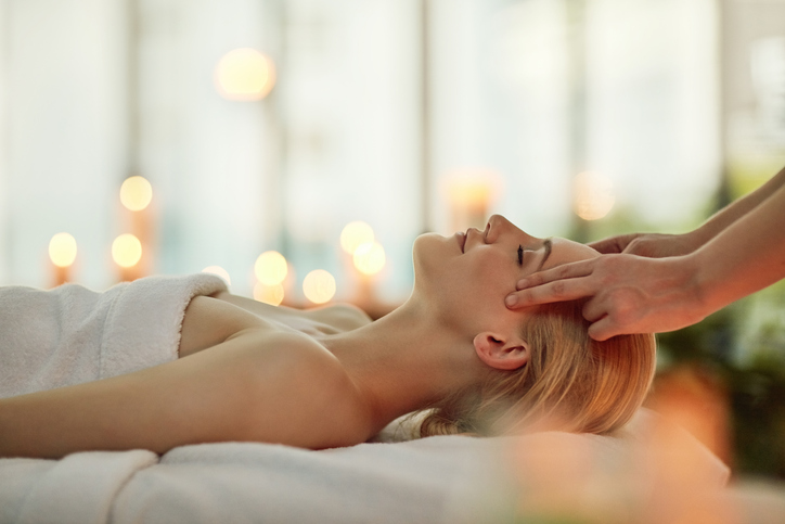 Cropped shot of a young woman enjoying a head massage at a spa