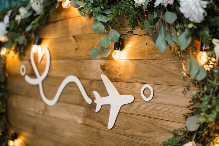 white plane on wooden boards decorated with flowers. distance and love. journey.