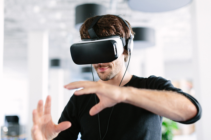 Man using virtual reality simulator headset