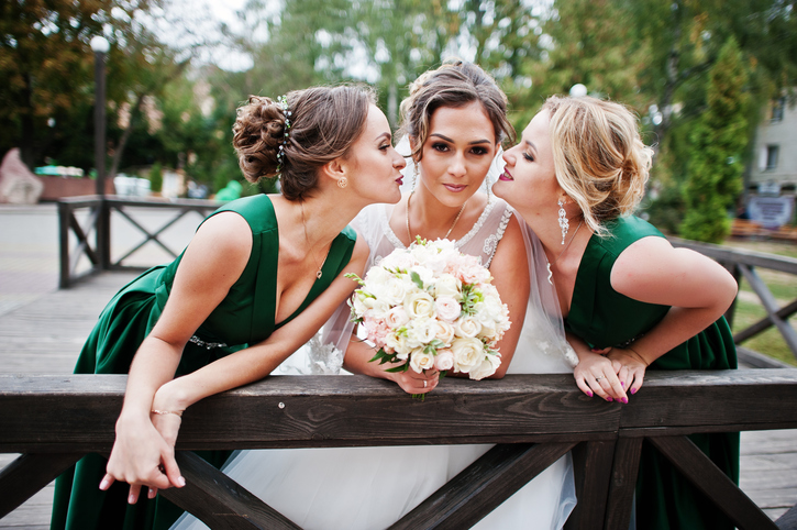 Fabulous bride walking, posing and having fun with her bridesmaids in the downtown on a wedding day.