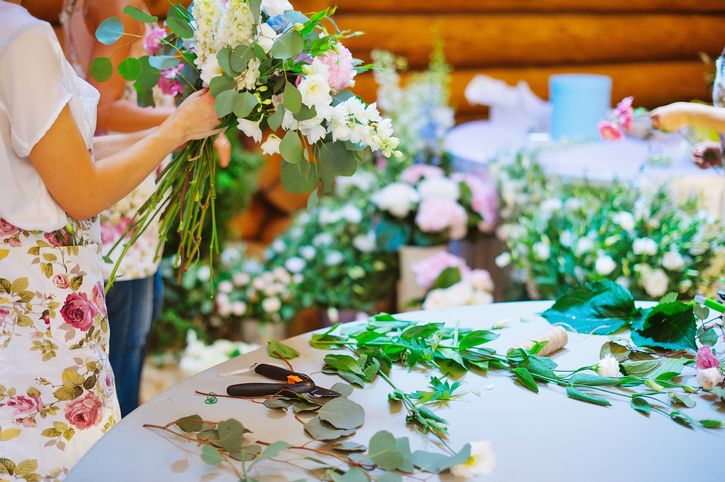 Hands of florist woman creating bouquets