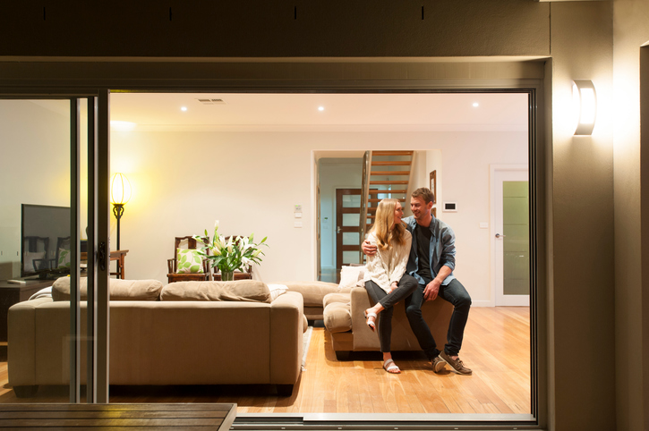 Couple relaxing in their home at night.