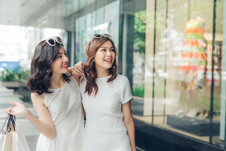 Beautiful asian girls with shopping bags walking on street at the mall