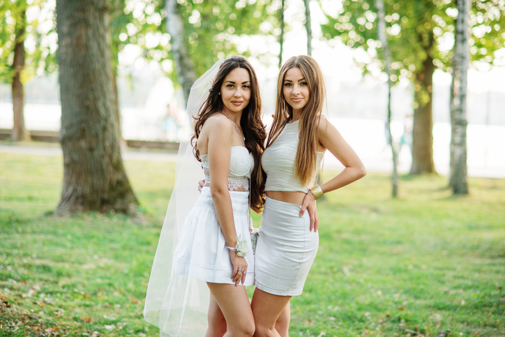 Two friends girls having fun on park at hen party.