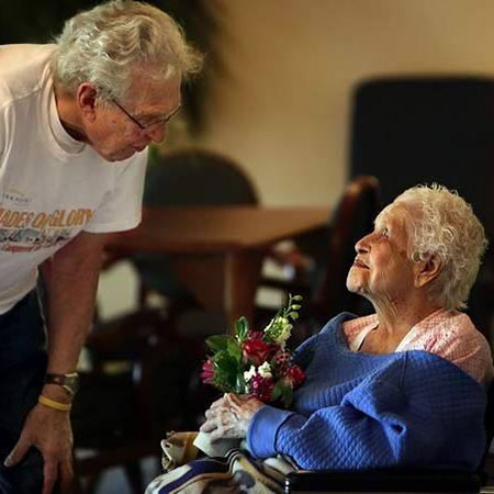 giving flowers to elderly people in homes
