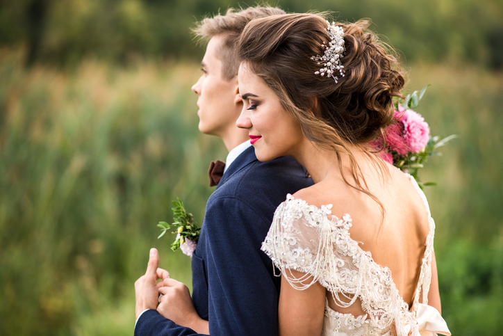 Bride and groom embracing in the park