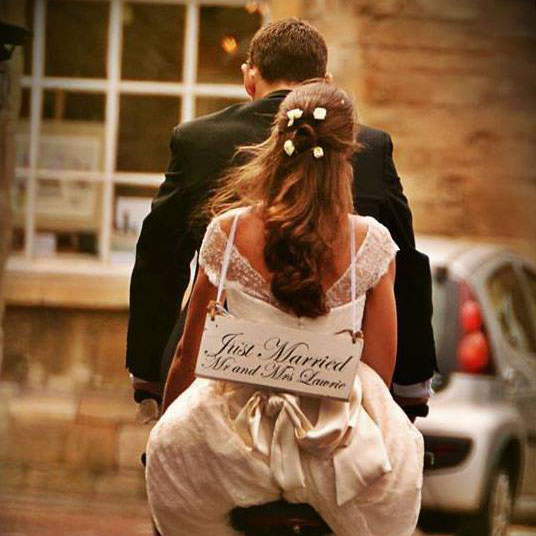 bride and groom on bike just married1