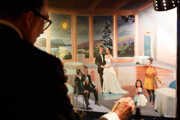 an artist painting the newlyweds on their wedding day