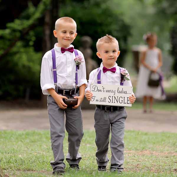 Page boys carrying wedding sign