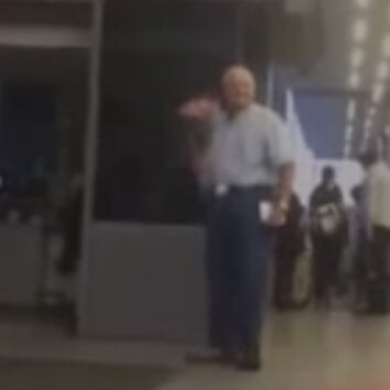 older man waits for wife at airport