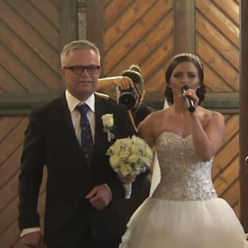 Bride sings as she walks down the aisle