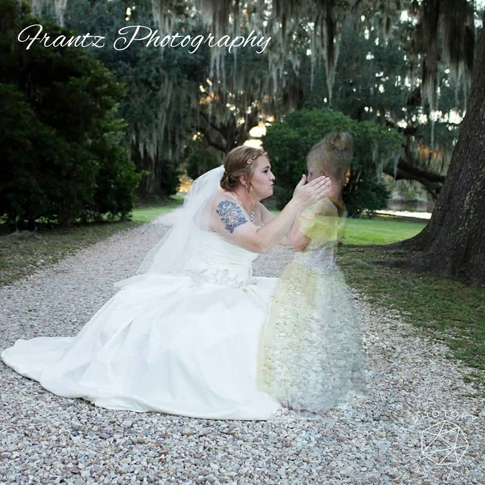 Bride Amanda had Azalee's handrawn picture (the three love hearts) swen into the back of her dress, as a special way to have her daughter involved during her wedding day. Image: Franz Photography via Facebook