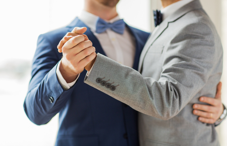 close up of happy male gay couple dancing