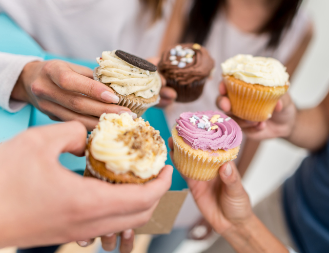 Group of friends eating cupcakes