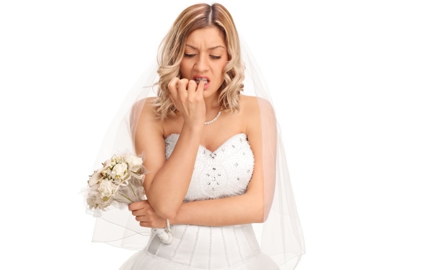Nervous bride biting her fingernails