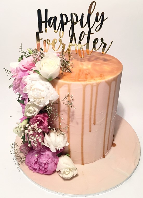 Caramel Drip cake with fresh flowers. Image Something About Cake