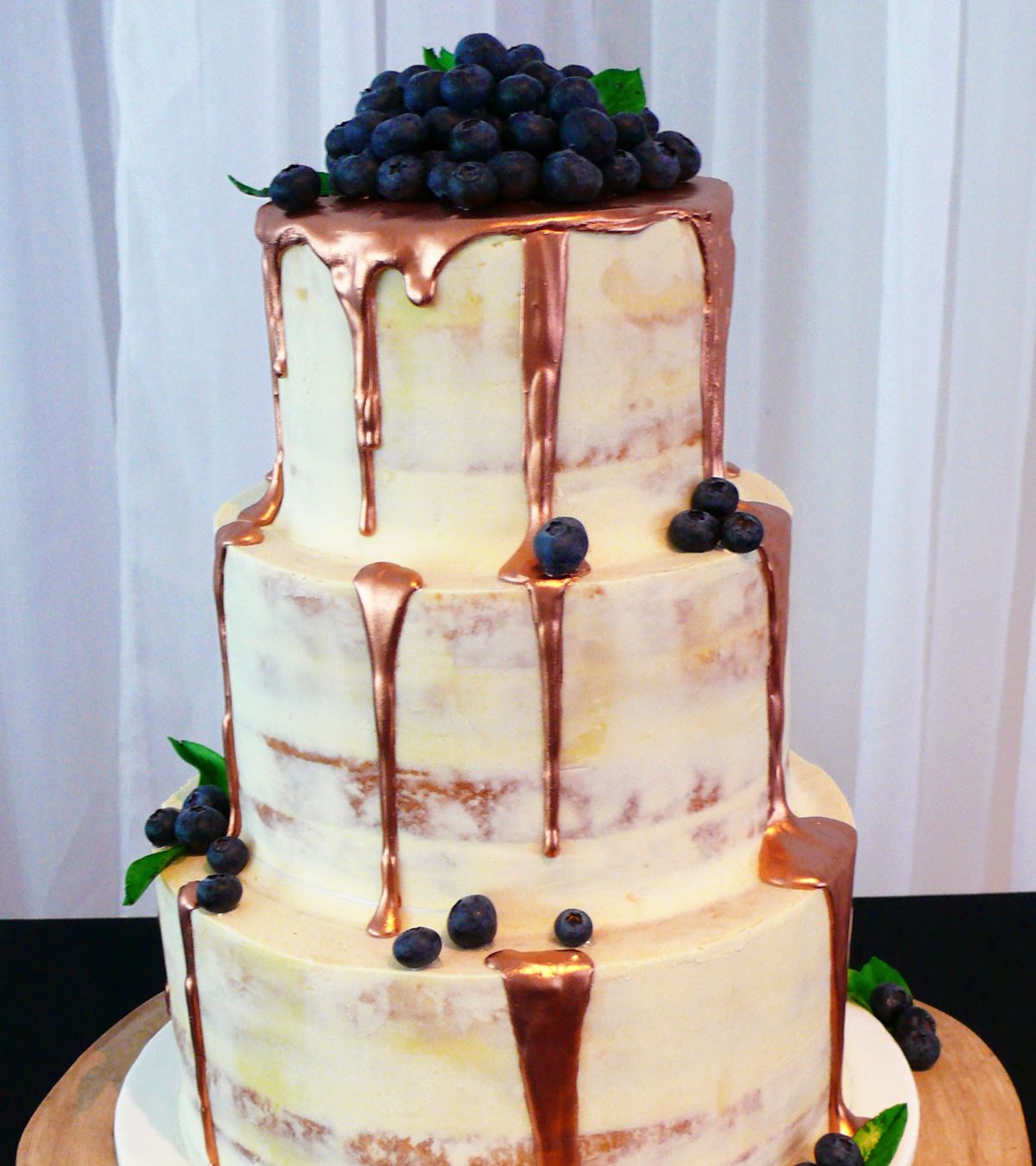 Copper drip naked wedding cake. Image J Poppet