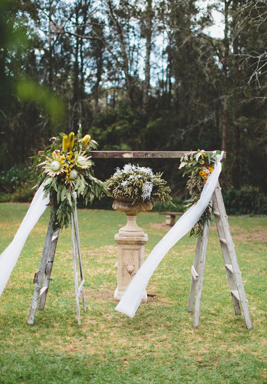 Vintage pottery mixed with wood and flowers makes a perfect rustic altar. Image: Willow and Dune