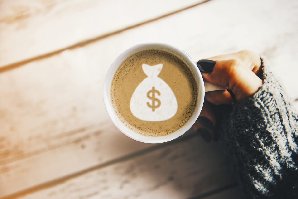 Girl with a cup of coffee with a money bag symbol