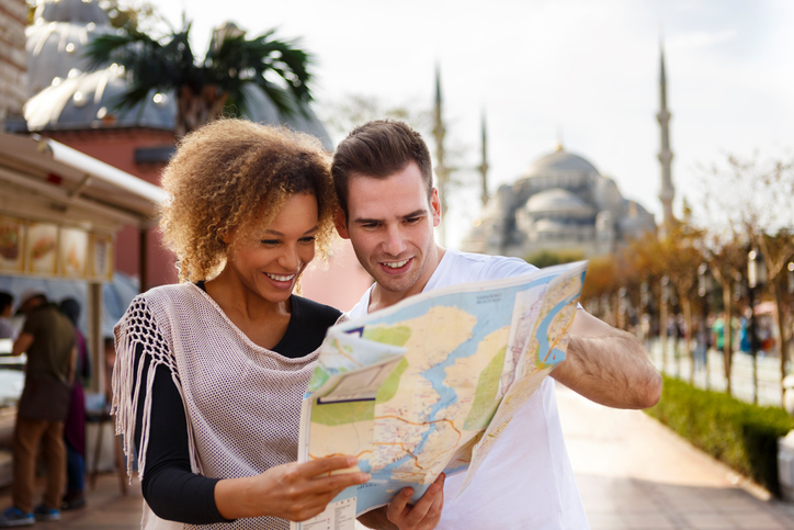 a couple viewing a map on their honeymoon