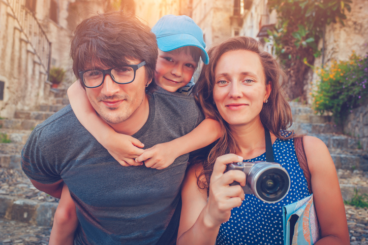 young newlywed couple on vacation with their child