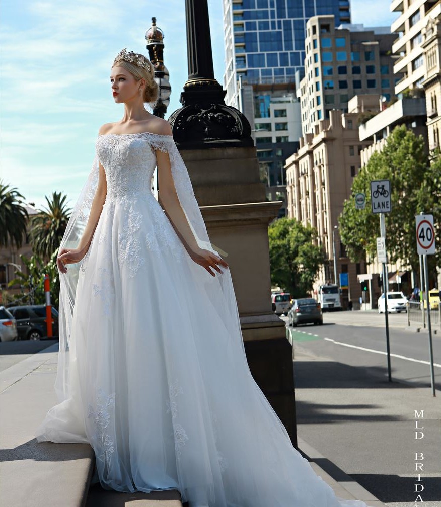 lace off the shoulder wedding dress with bridal cape MLD Bridal Studio e1499310998494