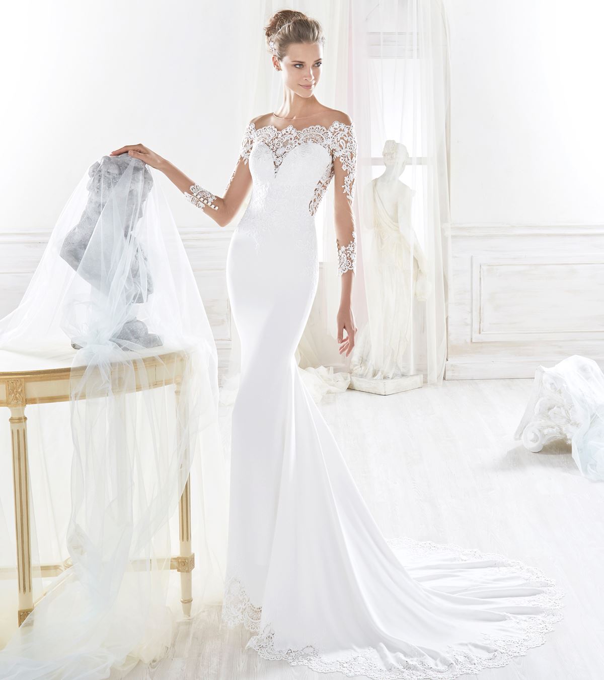 This Nicole Spose Wedding Dresses couples lace sleeves with an off the shoulder design.