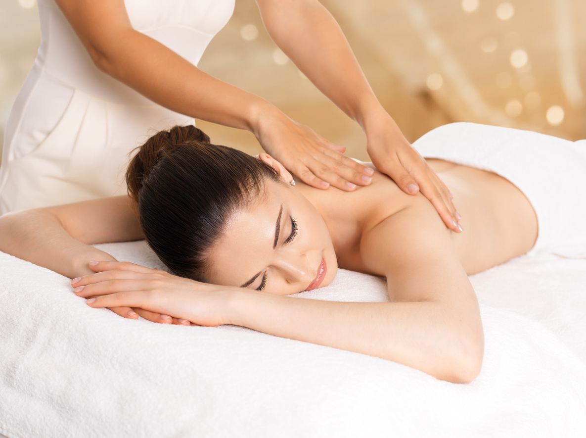 Woman having massage of body in spa salon