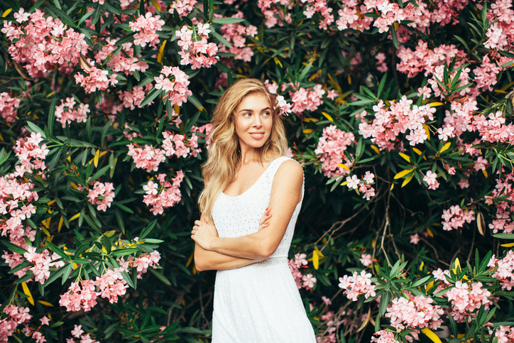 Beautiful girl on the background of spring bush