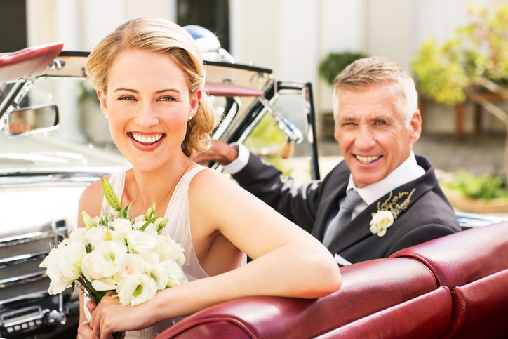 Happy Bride And Father Sitting In Convertible