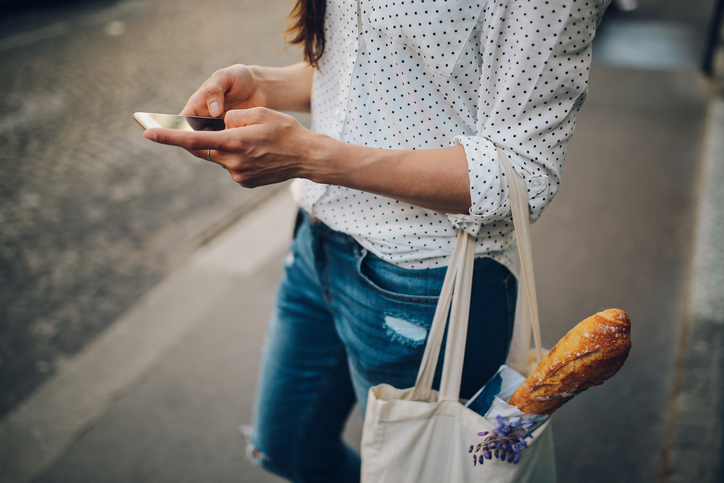 Young Parisian woman using the smartphone