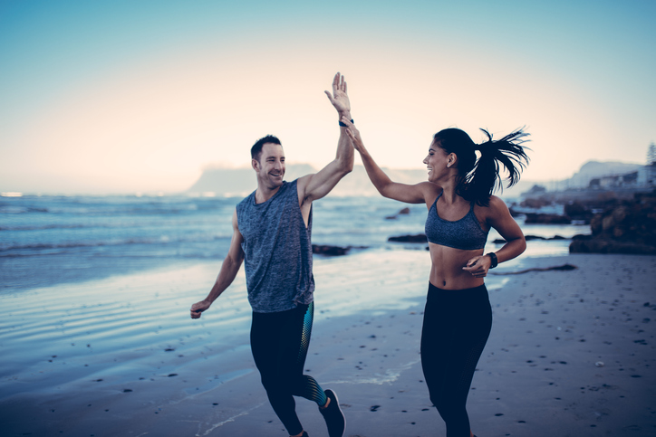 Fitness Couple giving each other high five after hard training