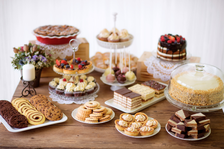 Table with various cookies, tarts, cakes, cupcakes and cakepops