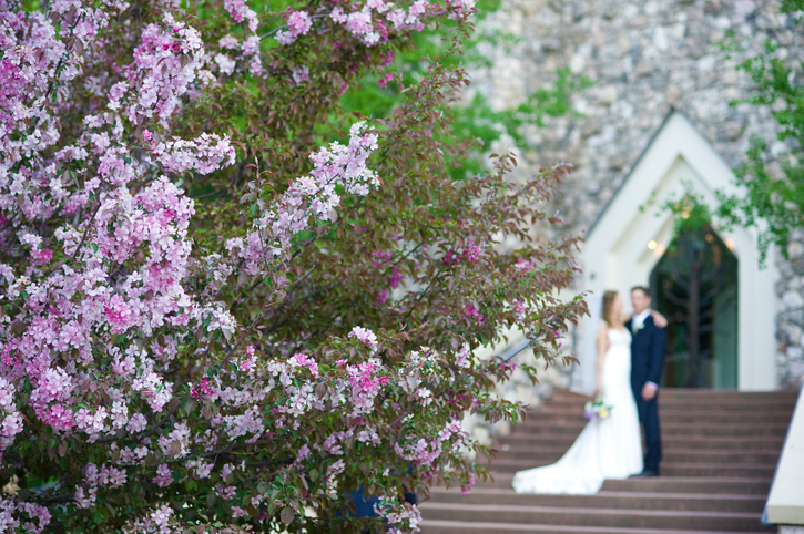 Bride and Groom on Steps of Wedding Chapel