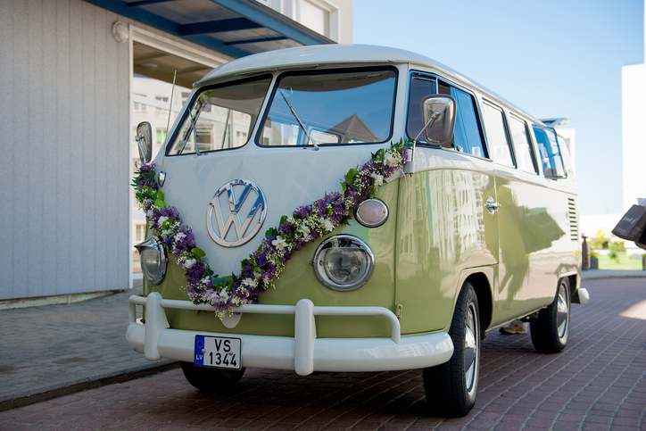 Green old Volkswagen bus decorated for wedding