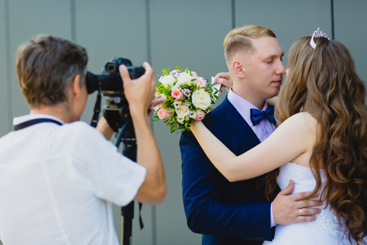 Photographer with Groom and Bride