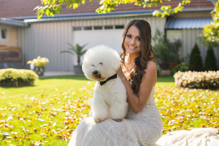 Bride posing on wedding day with dog