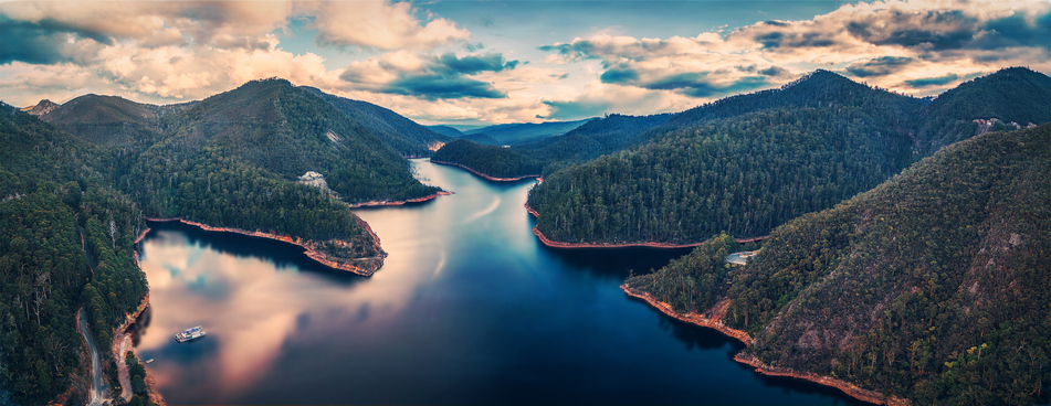 Beautiful Cethana lake and surrounding forest aerial panorama