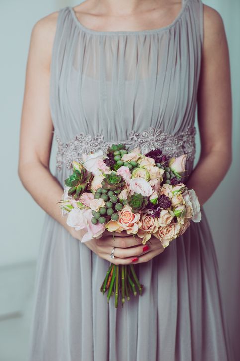 Image of wedding dress and floral bouquet.