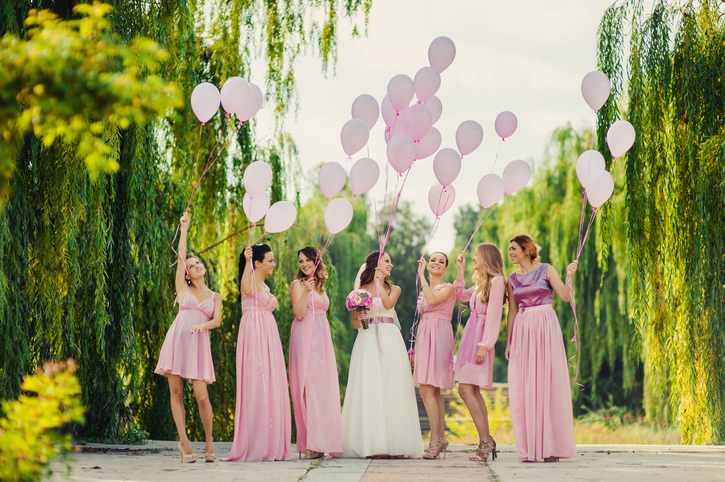 Bride with bridesmaids in pink dresses for a walk