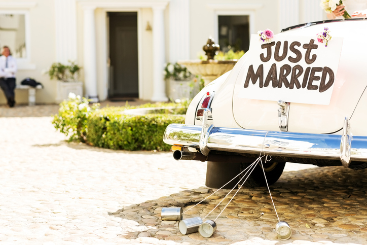 Just Married Sign And Cans Attached To Car
