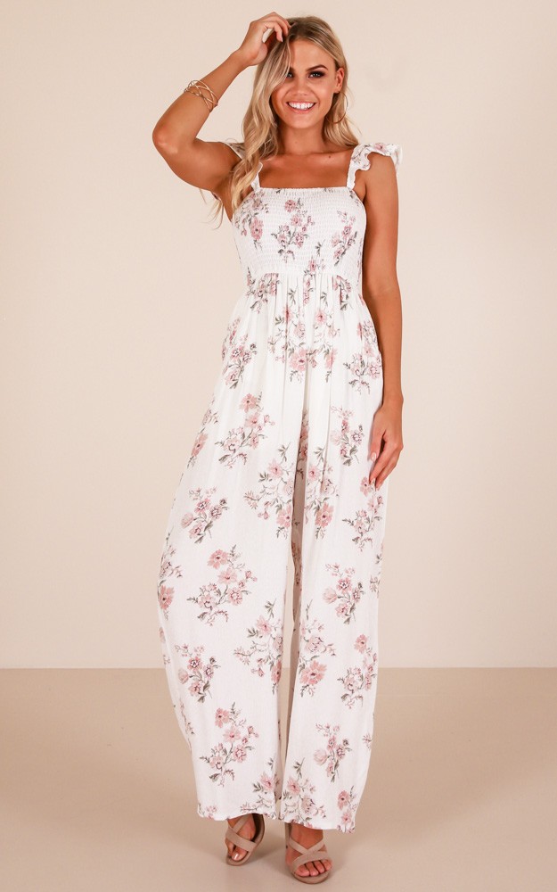 White jumpsuit store with flowers