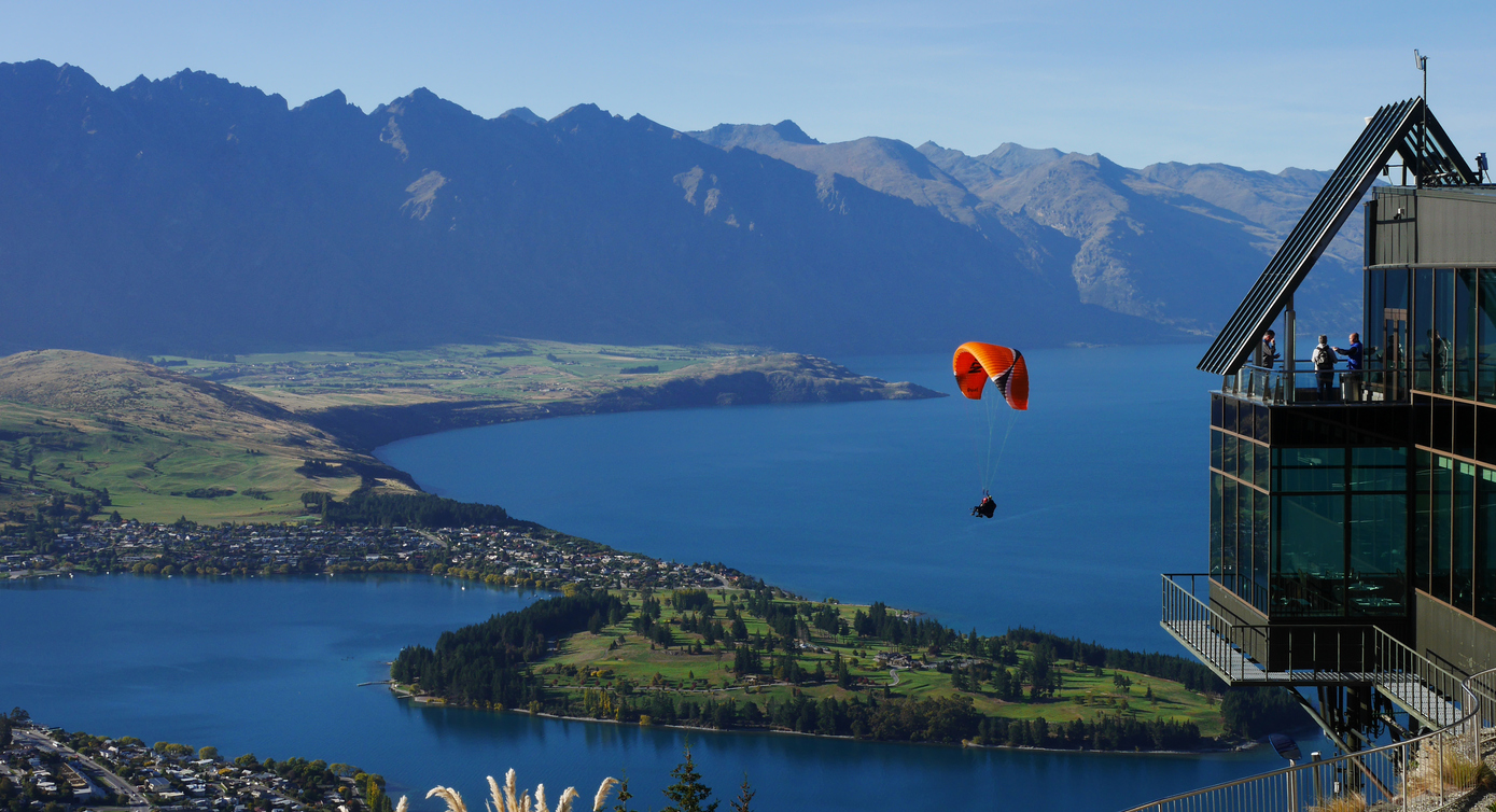 Queenstown, New Zealand - April 4, 2016. A paraglider flying above Queenstown and Lake Wakatipu. Queenstown is the premier adventure centre of New Zealand offering adrenalin pumping activities from bungy jumping to tandem skydiving.