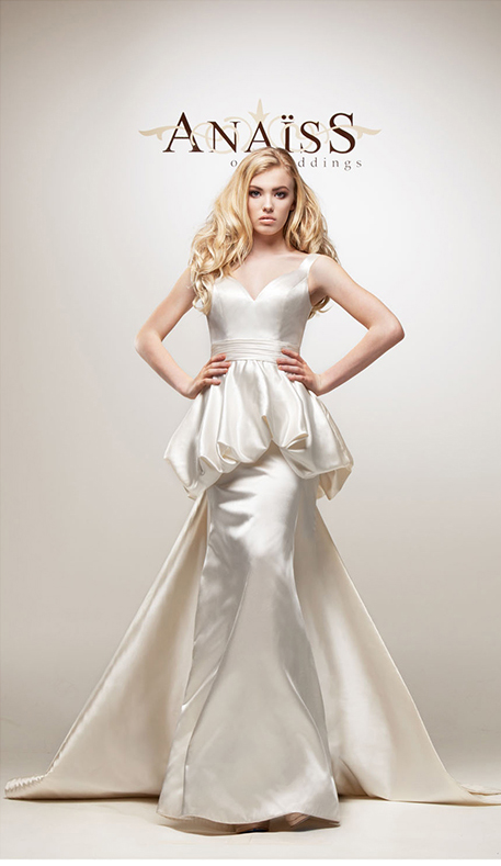 This tulle ball gown with shirred illusion V-neckline and shirred peplum is from Anaiss on Weddings