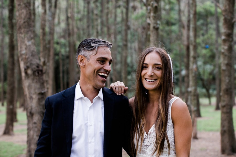 Bride and groom photograph in forest on wedding day