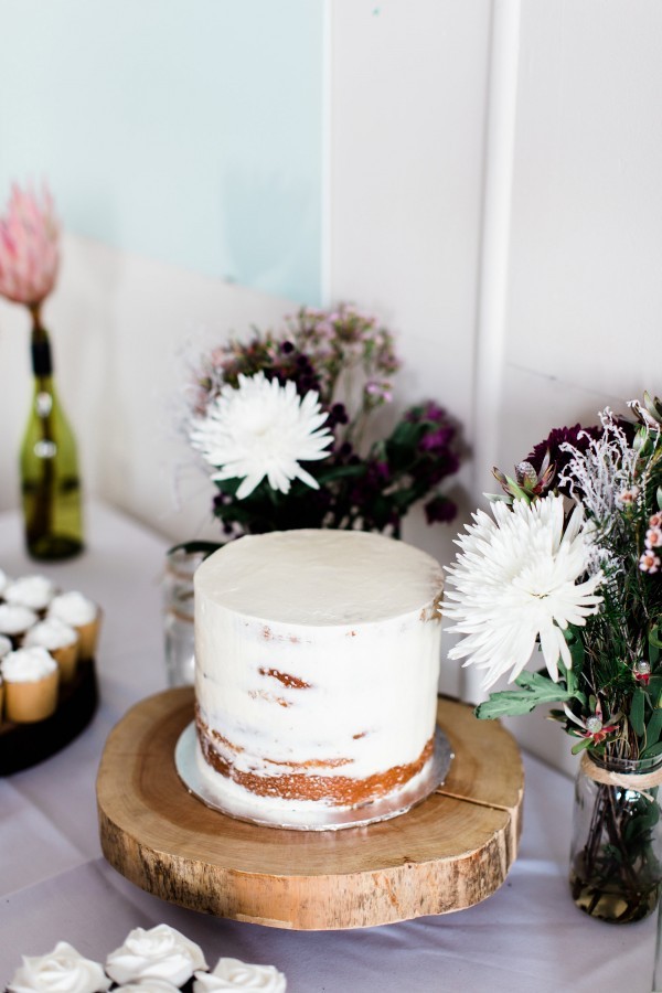 a wedding dessert table with semi naked wedding cake