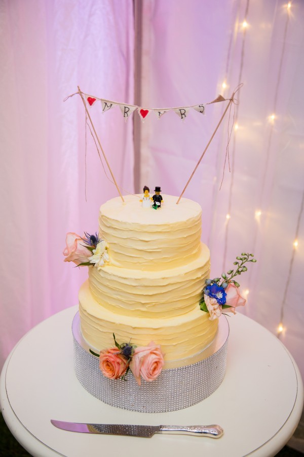 real wedding cake with cute bunting cake topper