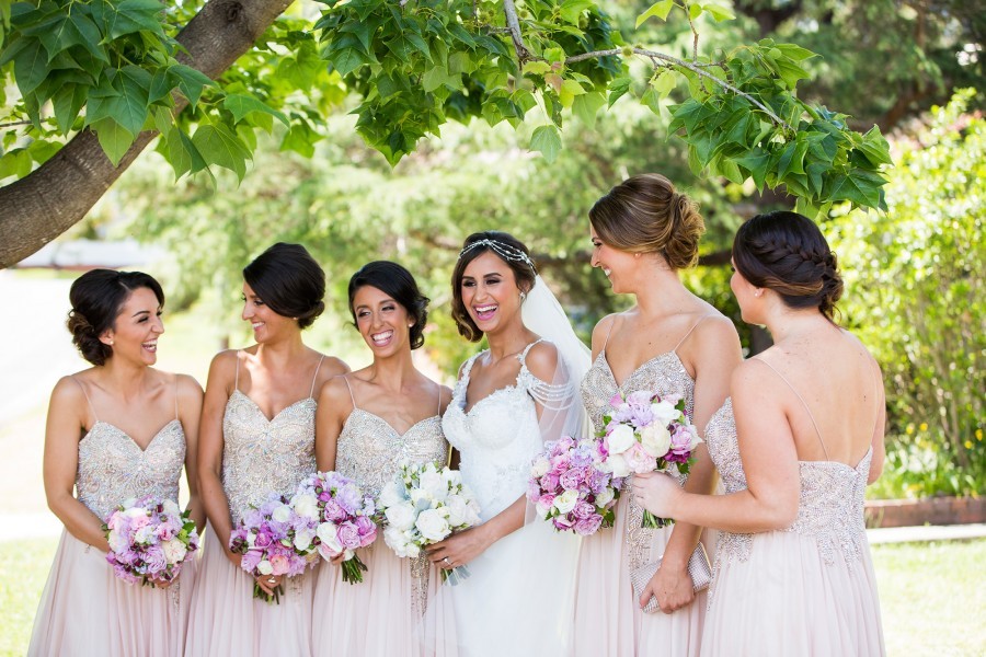 bride and he bridesmaids smiling