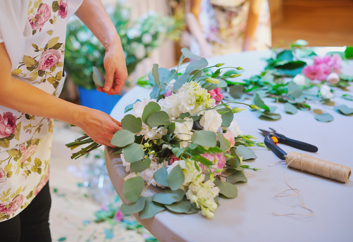 Hands of florist woman creating bouquets