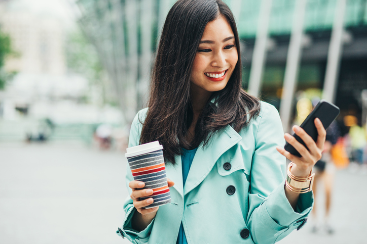 Attractive woman with phone and coffee